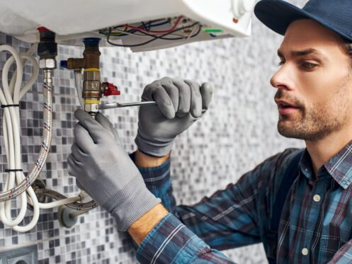 Dallas plumber performing professional water heater installation and repair.