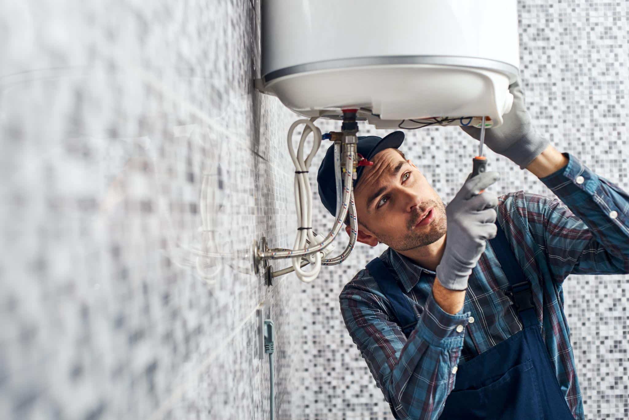 Expert plumber finishing a Dallas water heater replacement for a residential client.