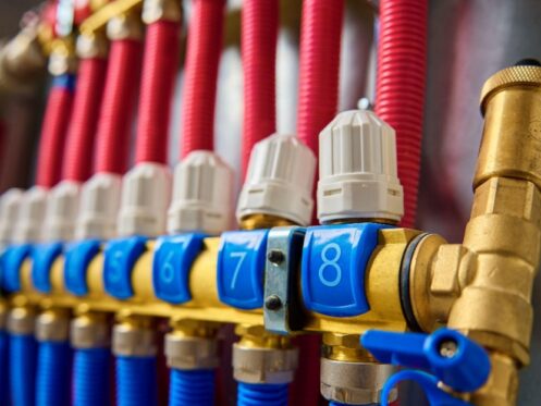 PEX supply lines and brass fittings in a Frisco home wall answering how long does PEX last.