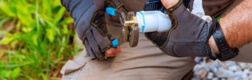 Plumber performing water line repair in Dallas TX on a corroded residential pipe at the main supply connection.