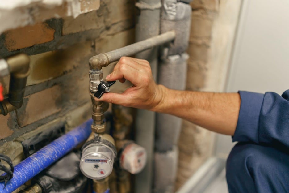 Plumber testing water pressure on a repaired supply line in Dallas TX before backfilling the trench. 